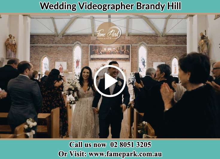 The newly weds walking through the well wishers Brandy Hill NSW 2324